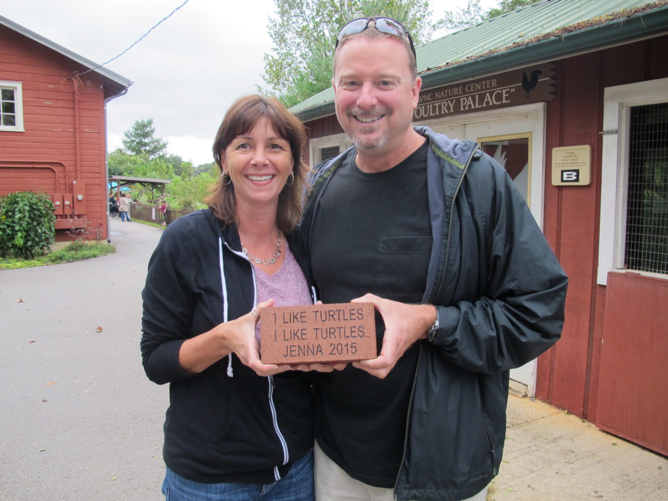 Couple holding an inscribed brick